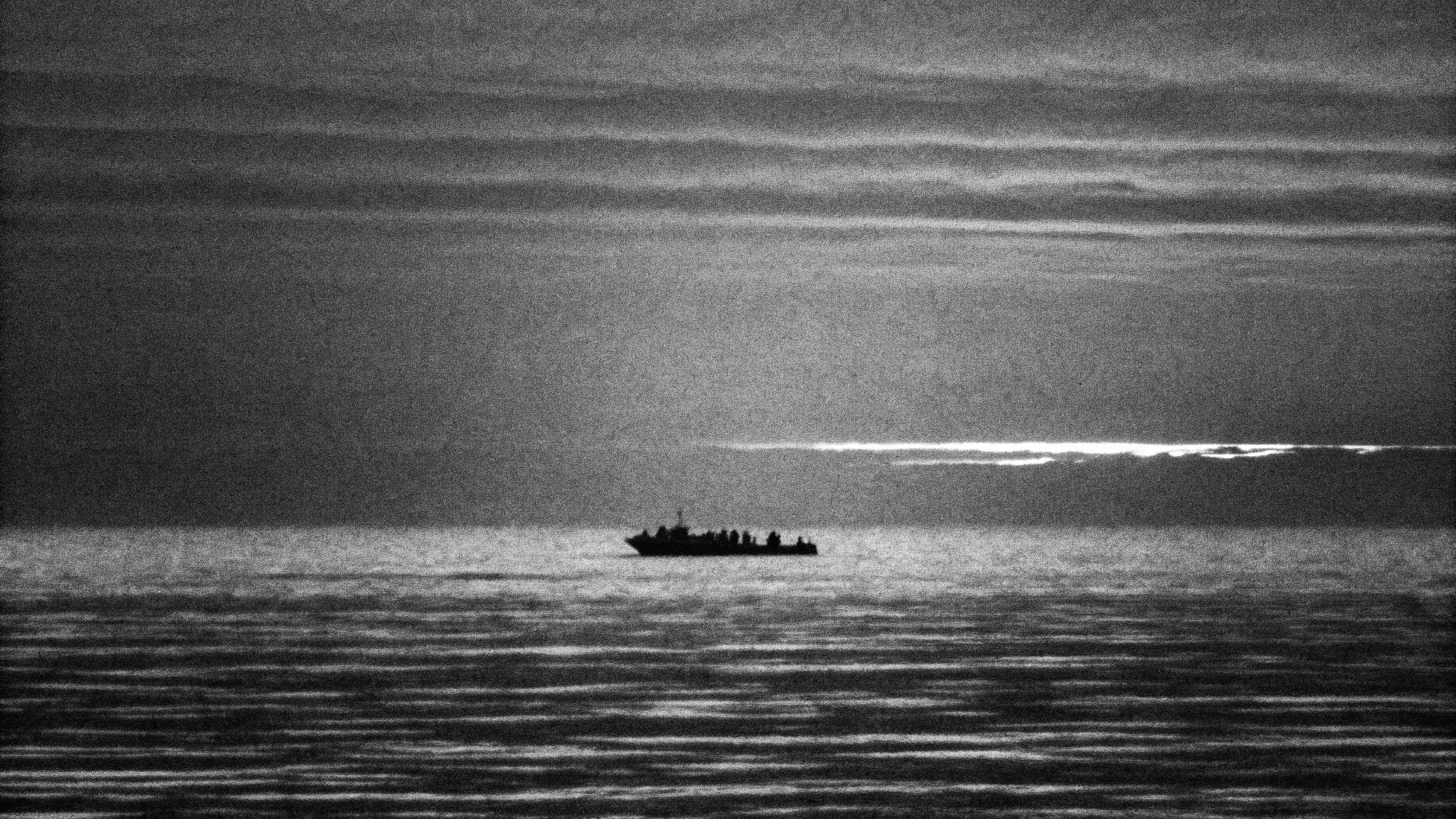 Illustration abstraite d’une embarcation de migrants au large de la Crète, avec des lumières de secours au loin