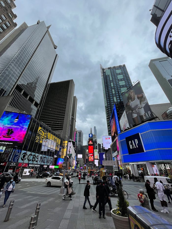 services-02 Lively view of Times Square with people walking, skyscrapers, and bustling signage in New York City.
