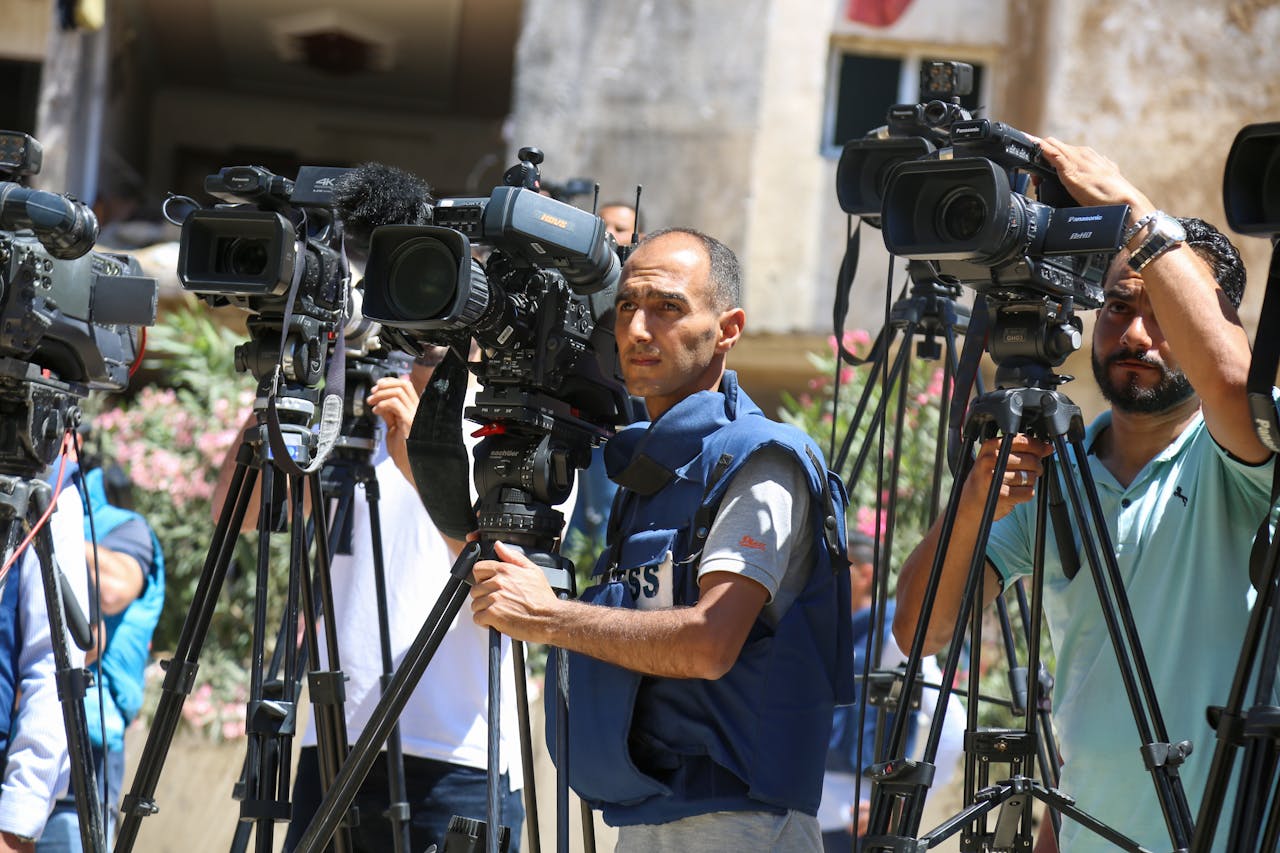 services-03 Journalists filming a live broadcast outdoors in Gaza Strip.